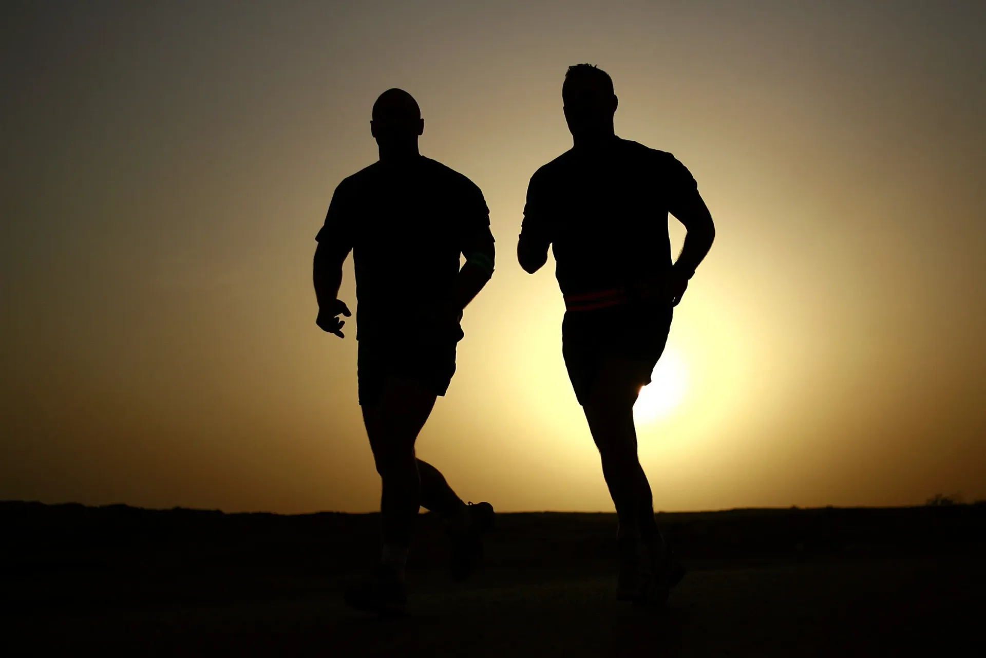 Group running session outdoors showing diverse participants jogging together, illustrating community-based coaching and collective fitness motivation.