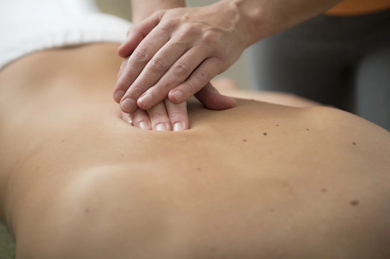 Therapeutic touch during treatment session, demonstrating compassionate, individualized care approach described in article.
