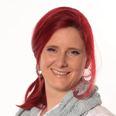 Professional headshot of Carmen Klatt with warm smile, establishing face-to-face trust and credibility as the clinic's lead therapist.