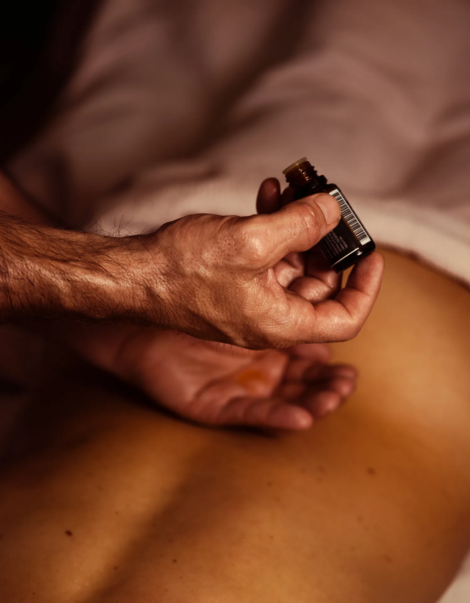 Therapist performing detailed foot reflexology by manipulating the client's toes and sole.