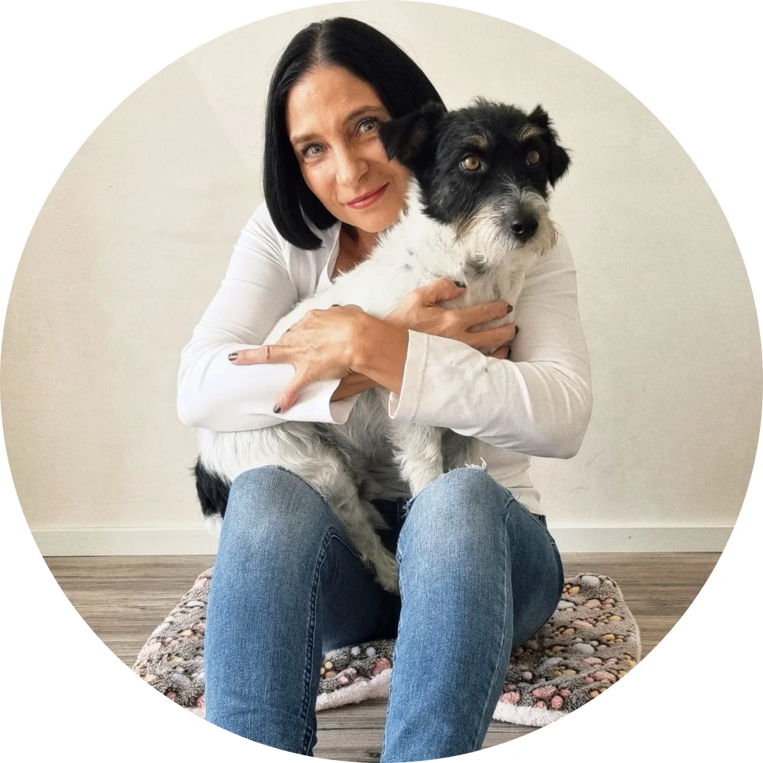 Severina holds her small dog in a calm, personal portrait conveying warmth and authenticity.