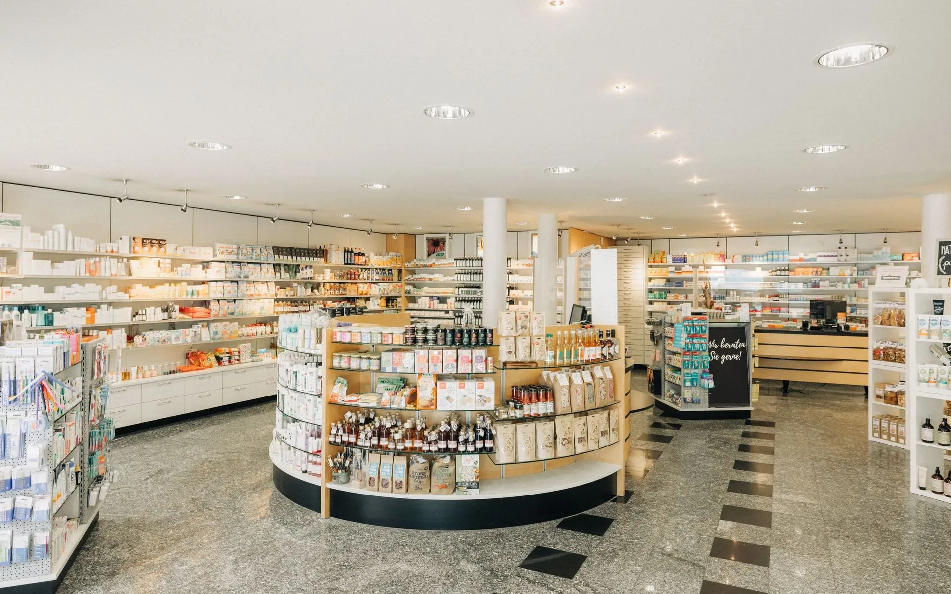 Bright, well-stocked pharmacy interior with shelves of health and wellness products.