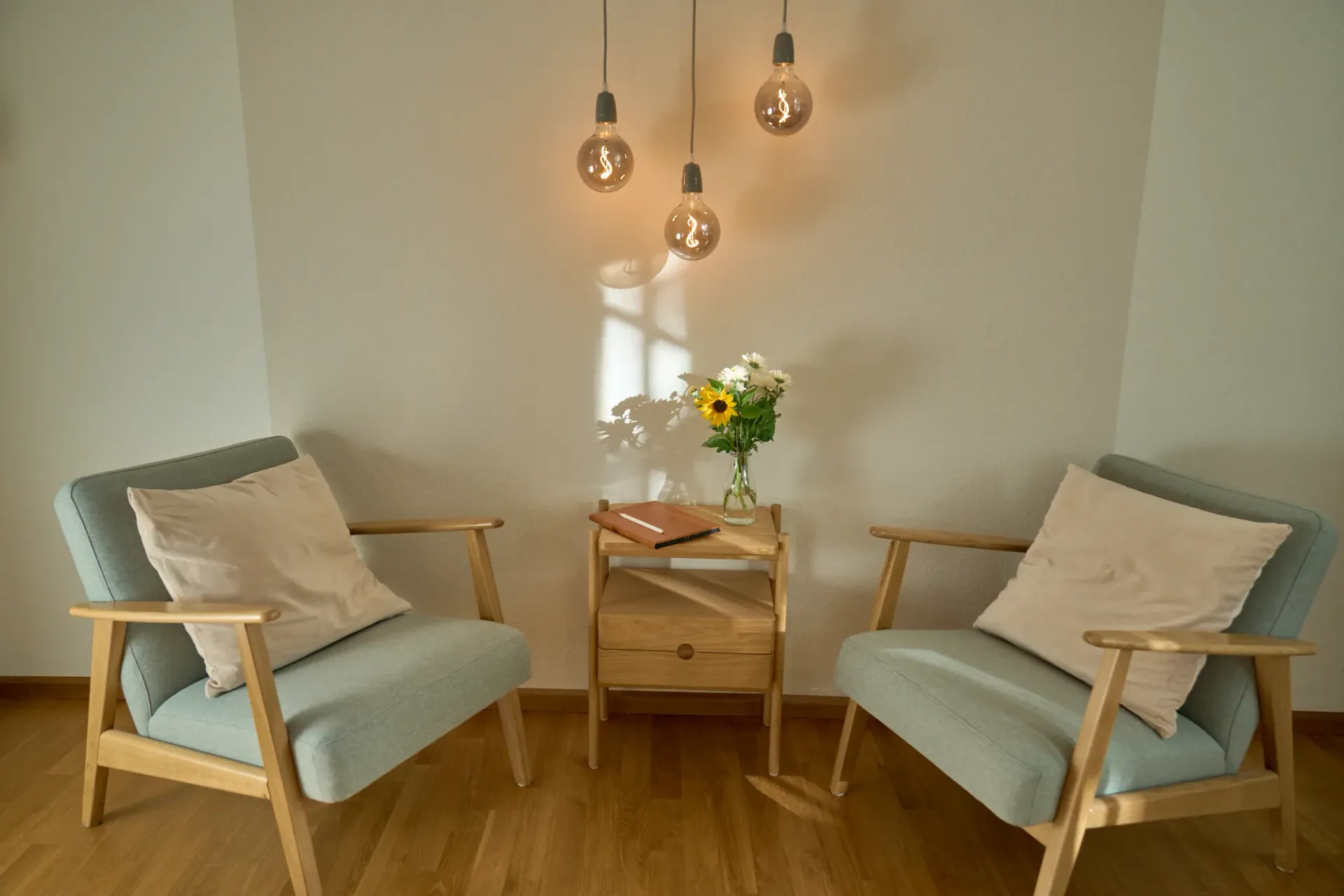 Serene therapy space with two chairs facing each other, symbolizing therapeutic encounter and mindful presence.