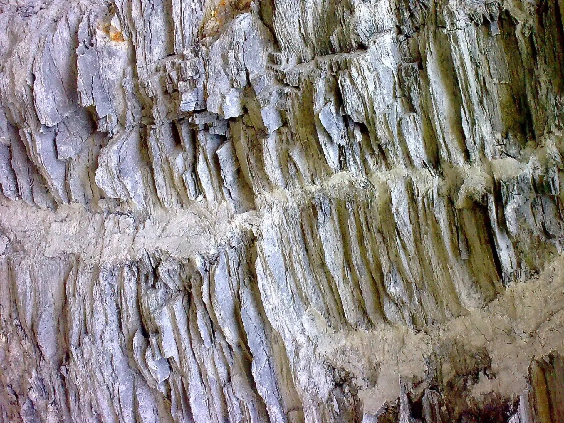Layered grey rock formations showing natural stratified texture and geological depth.