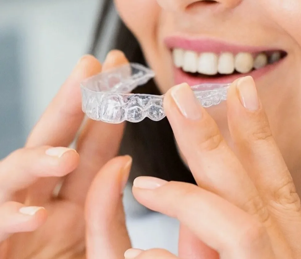 The Wintizahni dental practice logo featuring a stylized tooth icon in coral pink alongside the brand name in pink and dark blue.