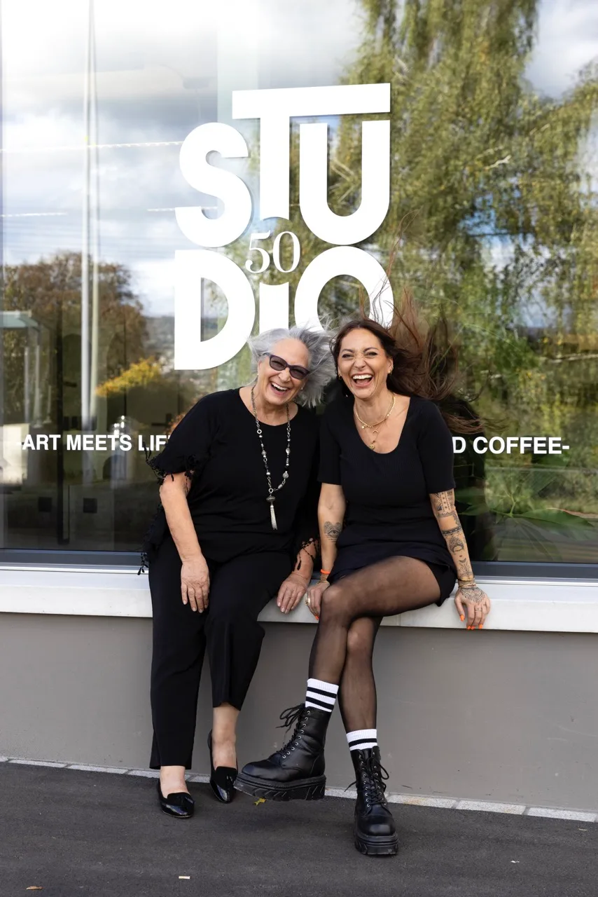 Two women laughing together outside Studio 50 — likely Christina and Michèle Uster, the mother-daughter duo behind this innovative Oberrieden studio.